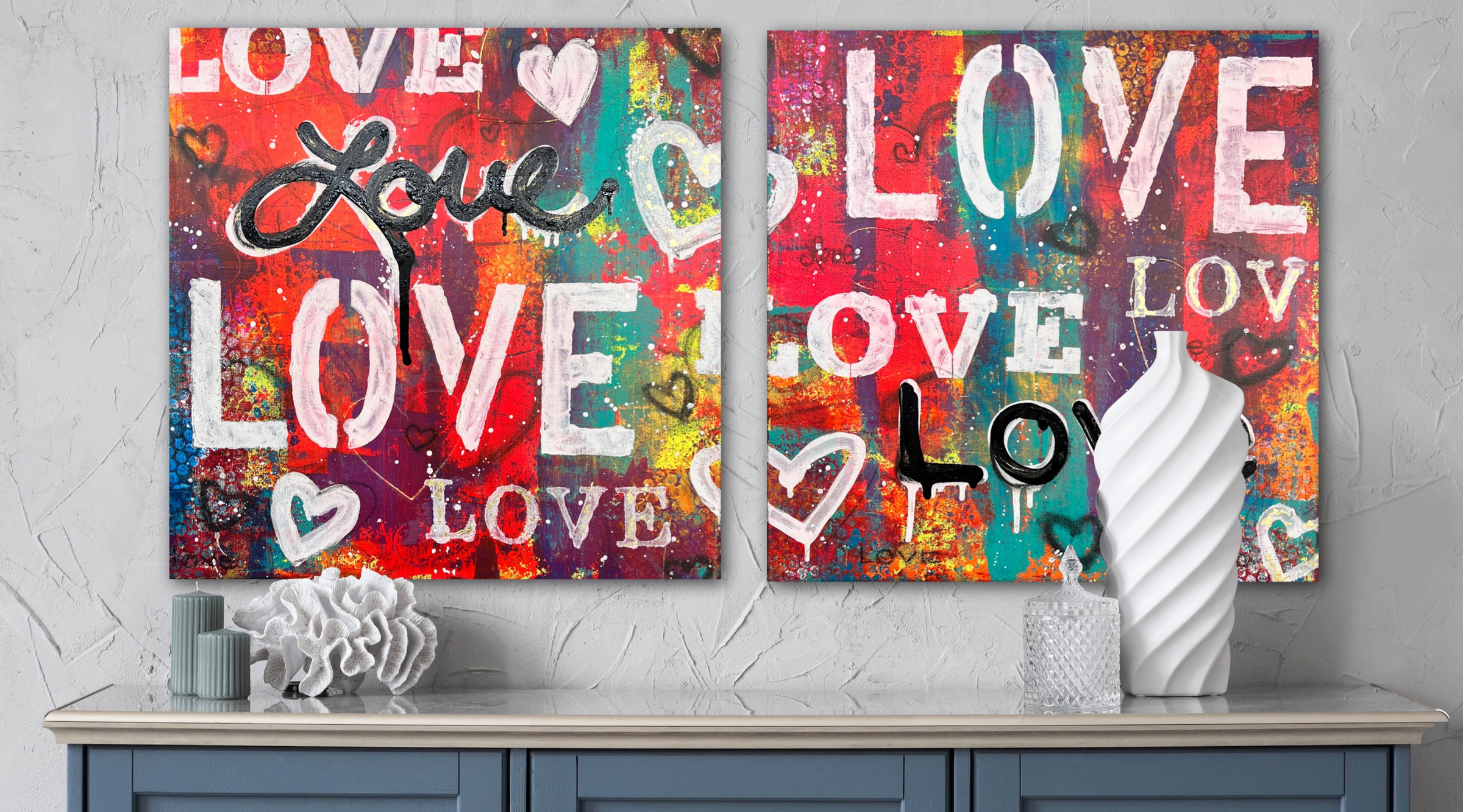 A pair of 'Love' canvas paintings by Shana Recker hung on the wall.